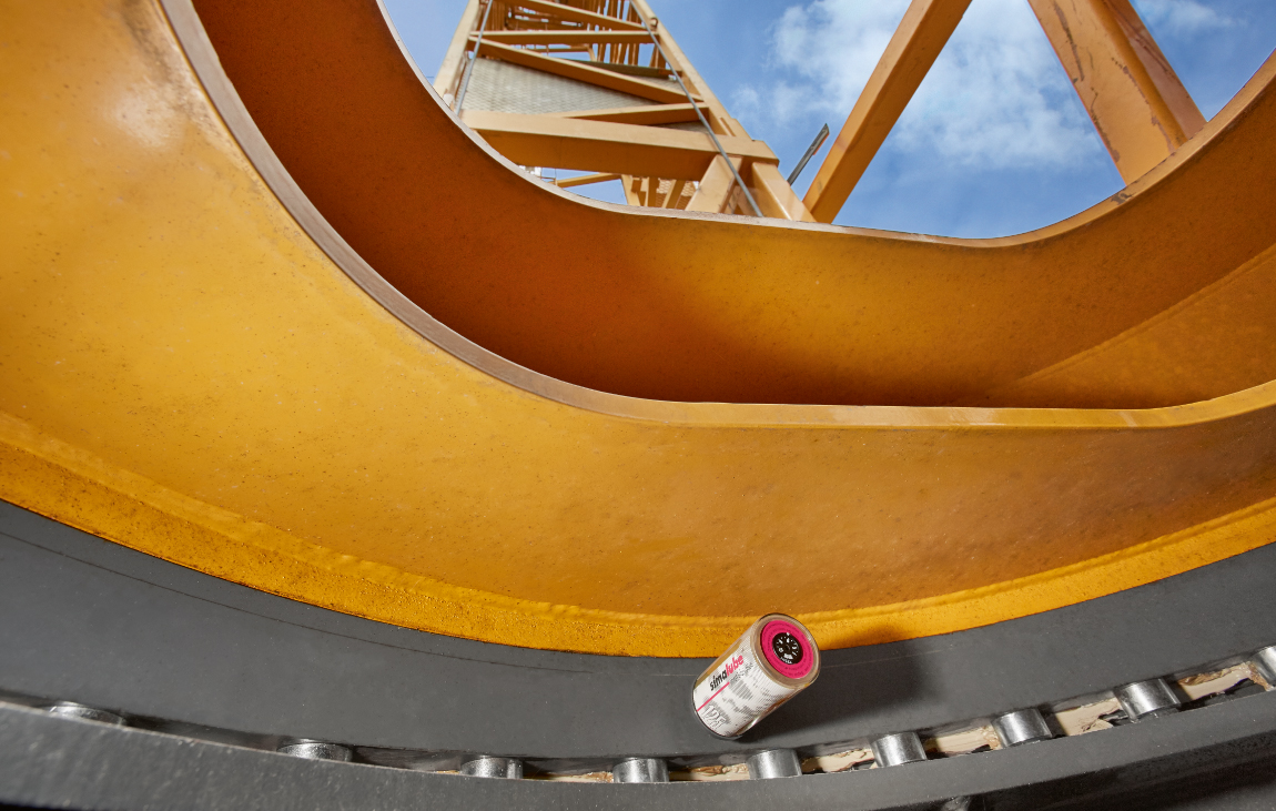 The roller bearing of the slewing ring of a construction crane is automatically and continuously lubricated with simalube lubricant dispensers.